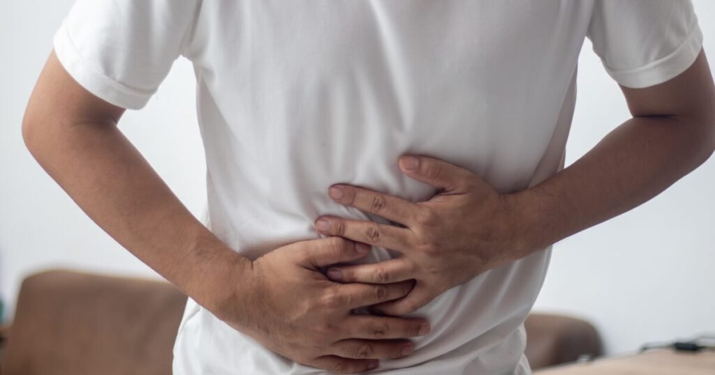 A Man Facing Stomach Cramps Due to Iron Pills