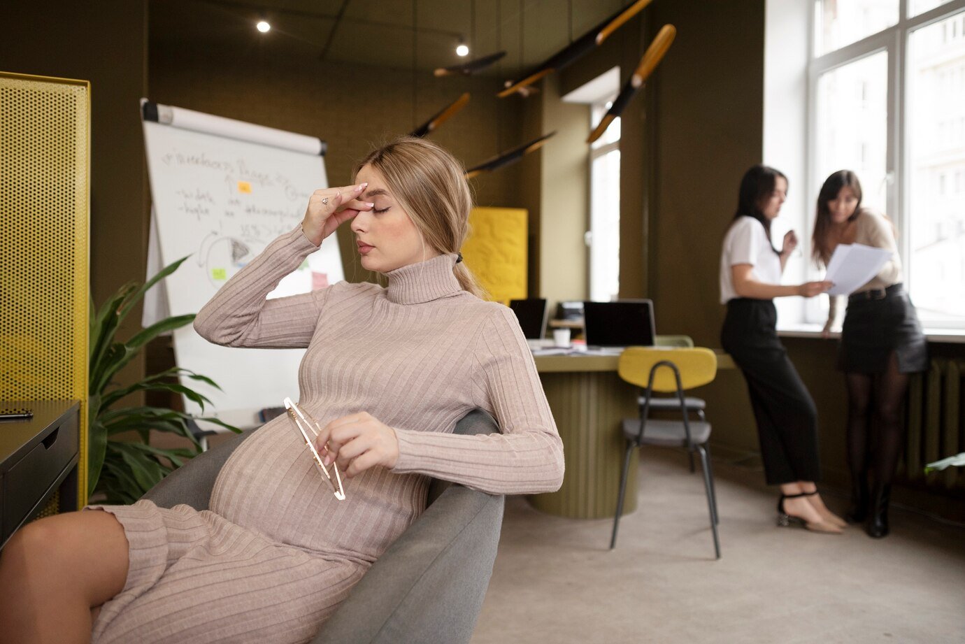 Pregnant woman at the office having a depression