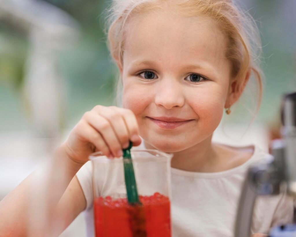 A glass of cranberry juice with fresh cranberries, highlighting safe consumption for toddlers and children.