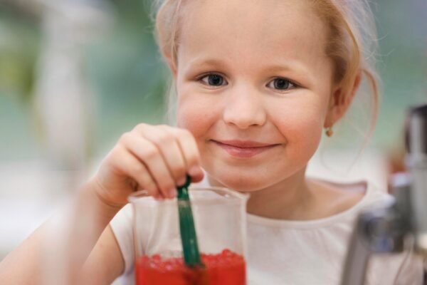A glass of cranberry juice with fresh cranberries, highlighting safe consumption for toddlers and children.