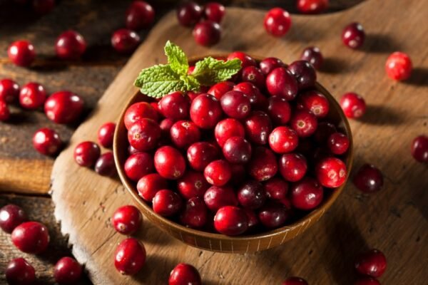 A glass of cranberry juice on a table, symbolizing post-tooth extraction considerations.