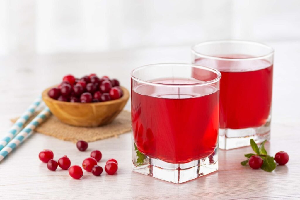 Cranberry juice in a glass with fresh cranberries, symbolizing detox support and hydration.