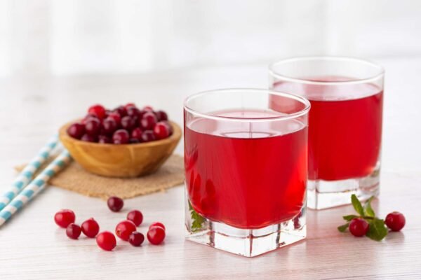 Cranberry juice in a glass with fresh cranberries, symbolizing detox support and hydration.