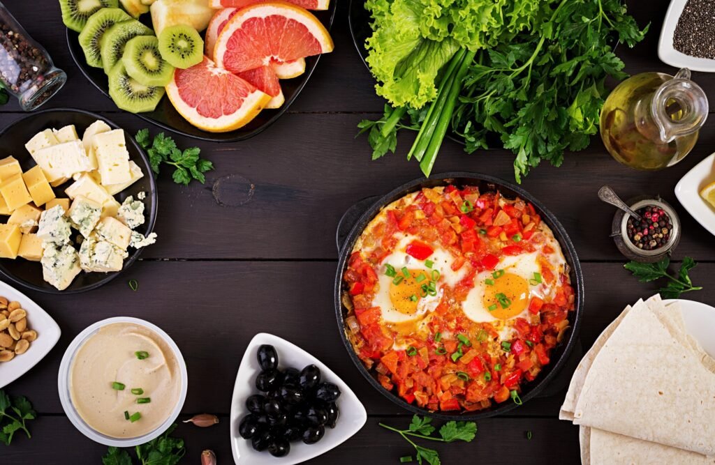 A plate with feta cheese, olives, tomatoes, cucumbers, whole-grain bread, and a boiled egg, served with Turkish coffee on a rustic wooden table.