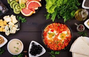 A plate with feta cheese, olives, tomatoes, cucumbers, whole-grain bread, and a boiled egg, served with Turkish coffee on a rustic wooden table.