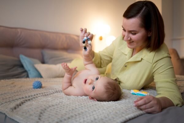 Newborn baby sleeping in daylight with mother holding near window and nighttime bassinet routine with soft light.